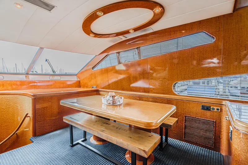 Slide: The Image of Luxurious dining area on a 1999 Horizon 70 Motor Yacht with elegant wood finishes. - 38