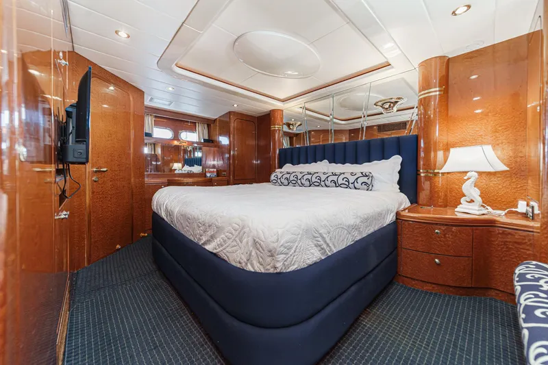 Slide: The Image of Luxurious bedroom interior of 1999 Horizon 70 Motor Yacht with elegant wood finishes. - 4