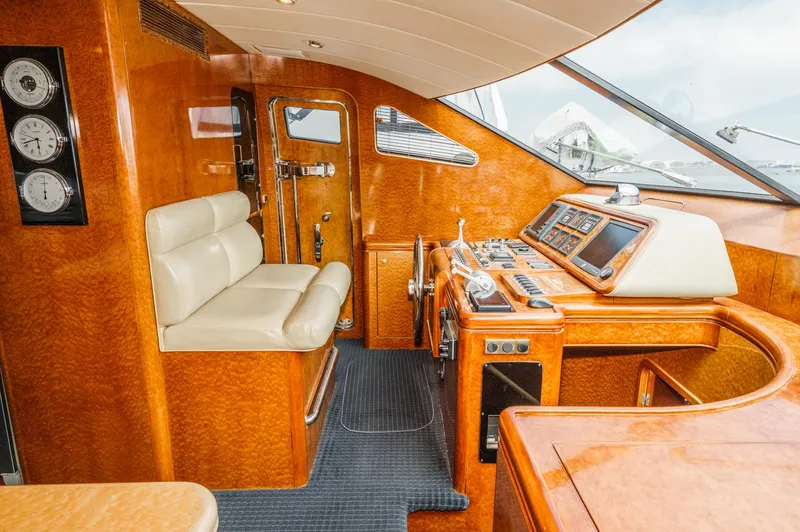 Slide: The Image of Luxurious interior of a 1999 Horizon 70 Motor Yacht with polished wood and leather seating. - 42