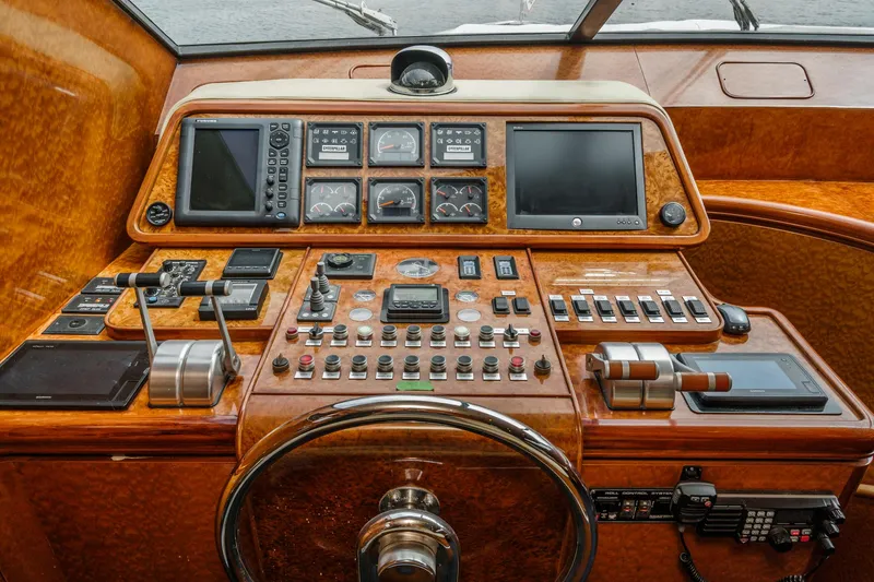 Slide: The Image of Control panel of a 1999 Horizon 70 Motor Yacht with navigation instruments and controls. - 43
