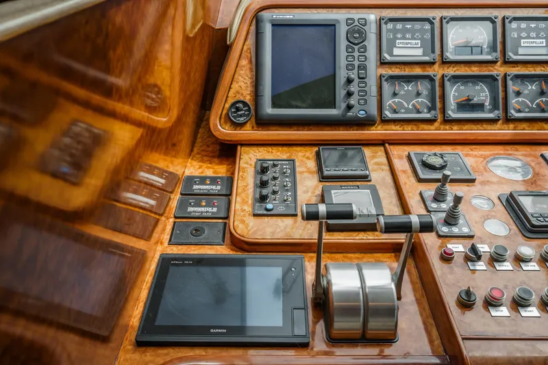 Slide: The Image of Control panel of a 1999 Horizon 70 Motor Yacht with navigation and monitoring instruments. - 44