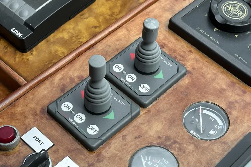 Slide: The Image of Control panel of a 1999 Horizon 70 Motor Yacht with joysticks and gauges. - 47