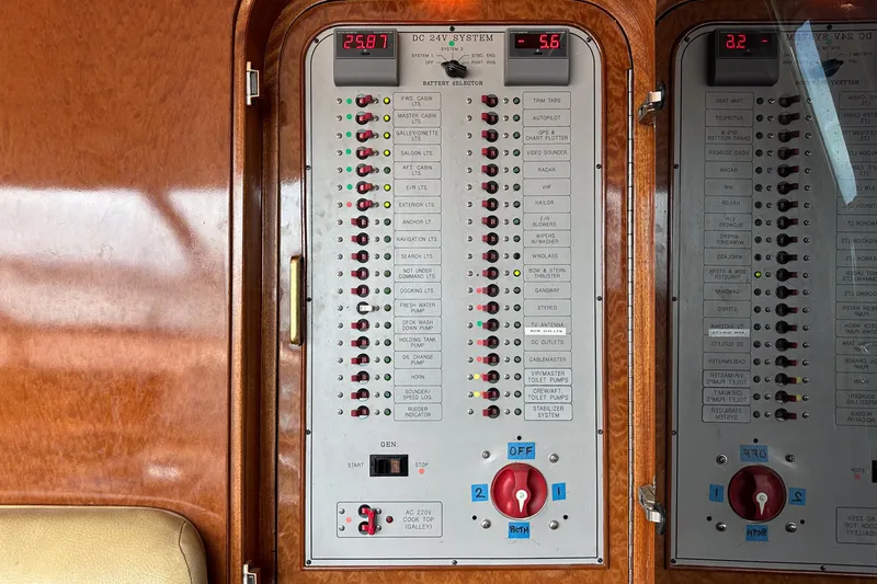 Slide: The Image of Control panel of a 1999 Horizon 70 Motor Yacht with various switches and indicators. - 49