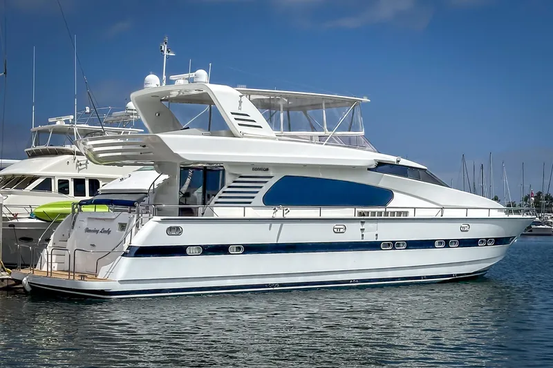 Slide: The Image of 1999 Horizon 70 Motor Yacht docked in marina, featuring sleek design and spacious deck. - 6