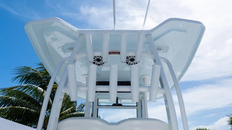 Slide: The Image of 2026 Tidewater 282CC Adventure boat with rod holders and speakers under a clear sky. - 10