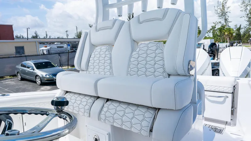 Slide: The Image of Luxury seating on 2026 Tidewater 282CC Adventure boat, featuring stylish white upholstery. - 12