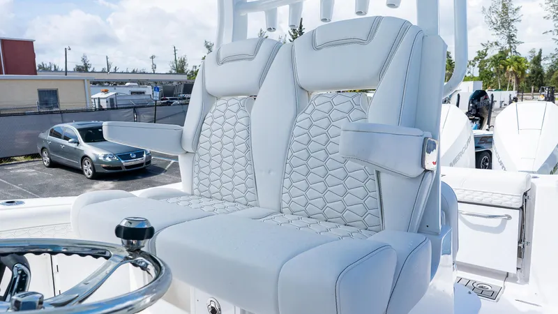 Slide: The Image of 2026 Tidewater 282CC Adventure boat with luxurious white seating and steering wheel. - 13