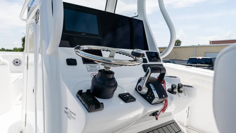 Slide: The Image of 2026 Tidewater 282CC Adventure boat helm with steering wheel and control panel. - 15