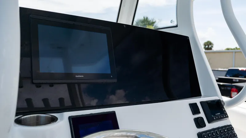 Slide: The Image of 2026 Tidewater 282CC Adventure boat dashboard with Garmin display and controls. - 16
