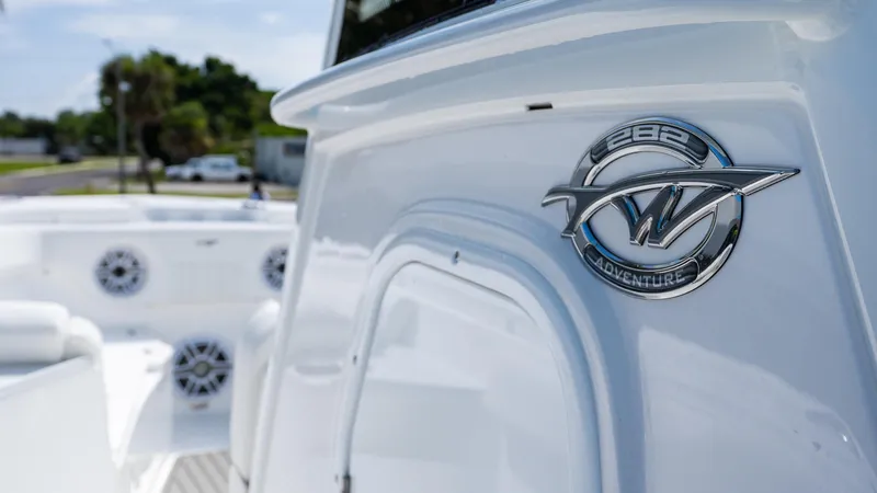 Slide: The Image of 2026 Tidewater 282CC Adventure boat emblem, sleek white design, outdoor setting. - 17