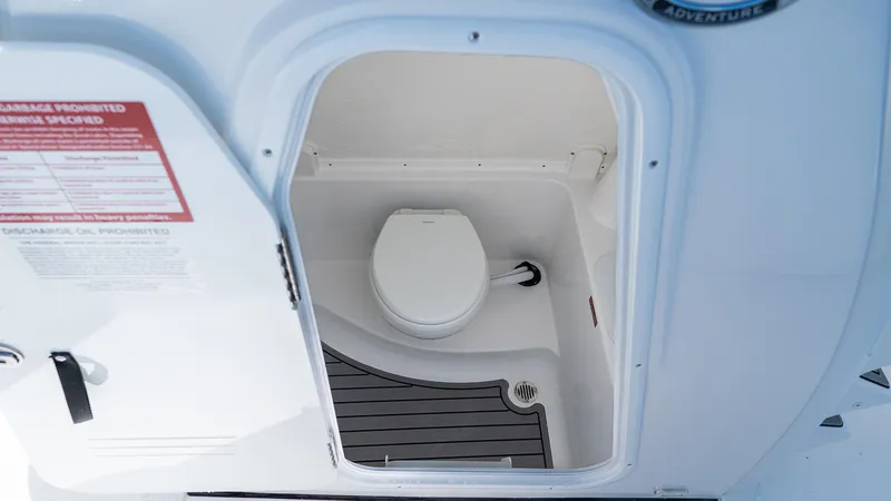 Slide: The Image of 2026 Tidewater 282CC Adventure boat interior with compact marine toilet. - 18