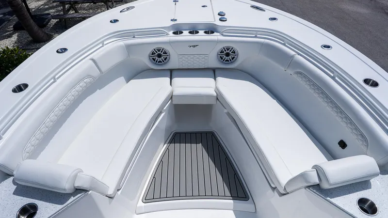 Slide: The Image of 2026 Tidewater 282CC Adventure boat interior with white cushioned seating and speakers. - 21