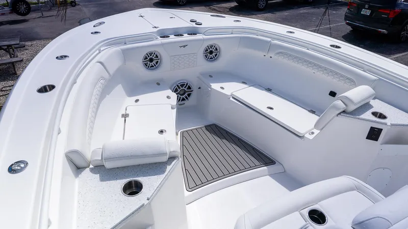 Slide: The Image of 2026 Tidewater 282CC Adventure boat interior with white seating and cup holders. - 23
