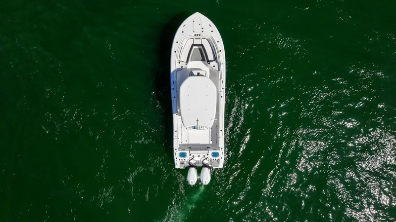 Slide: The Image of Aerial view of 2026 Tidewater 282CC Adventure boat on green water. - 29