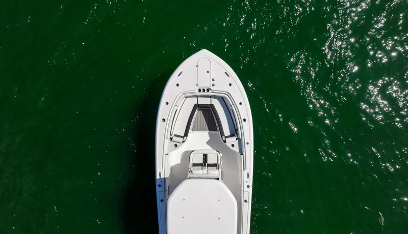 Slide: The Image of Overhead view of 2026 Tidewater 282CC Adventure boat on green water. - 30