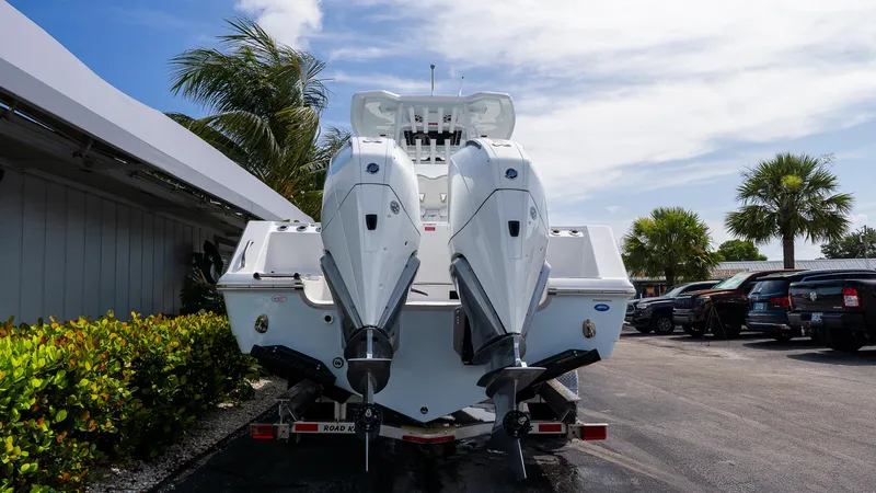 Slide: The Image of 2026 Tidewater 282CC Adventure boat with dual outboard engines, parked outdoors. - 4