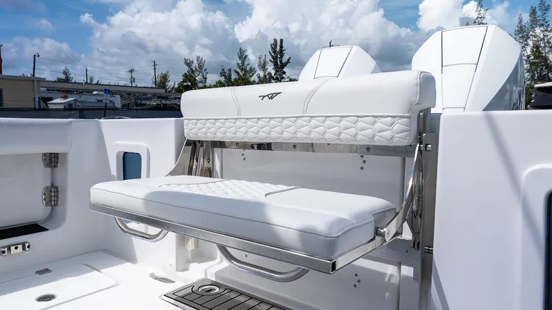 Slide: The Image of 2026 Tidewater 282CC Adventure boat with white cushioned seating and sleek design. - 6