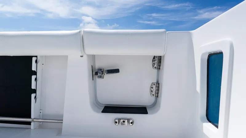 Slide: The Image of 2026 Tidewater 282CC Adventure boat interior detail with white upholstery and blue sky background. - 7