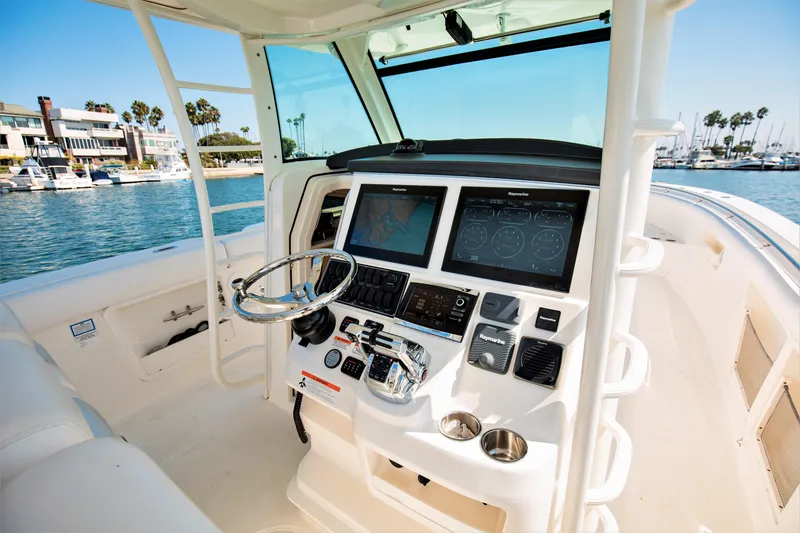 Slide: The Image of 2014 Boston Whaler 370 Outrage helm with advanced navigation systems and controls. - 12