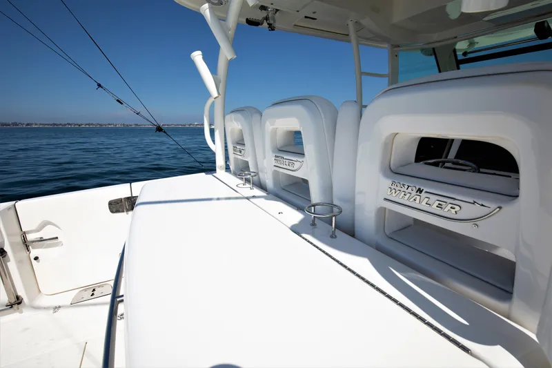Slide: The Image of 2014 Boston Whaler 370 Outrage boat interior with seating and ocean view. - 16