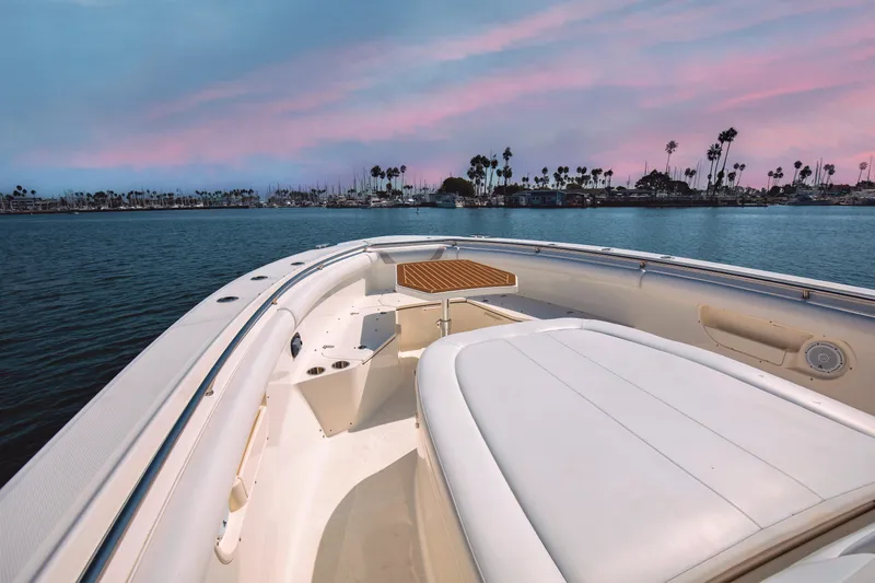 Slide: The Image of 2014 Boston Whaler 370 Outrage boat on calm water at sunset. - 8