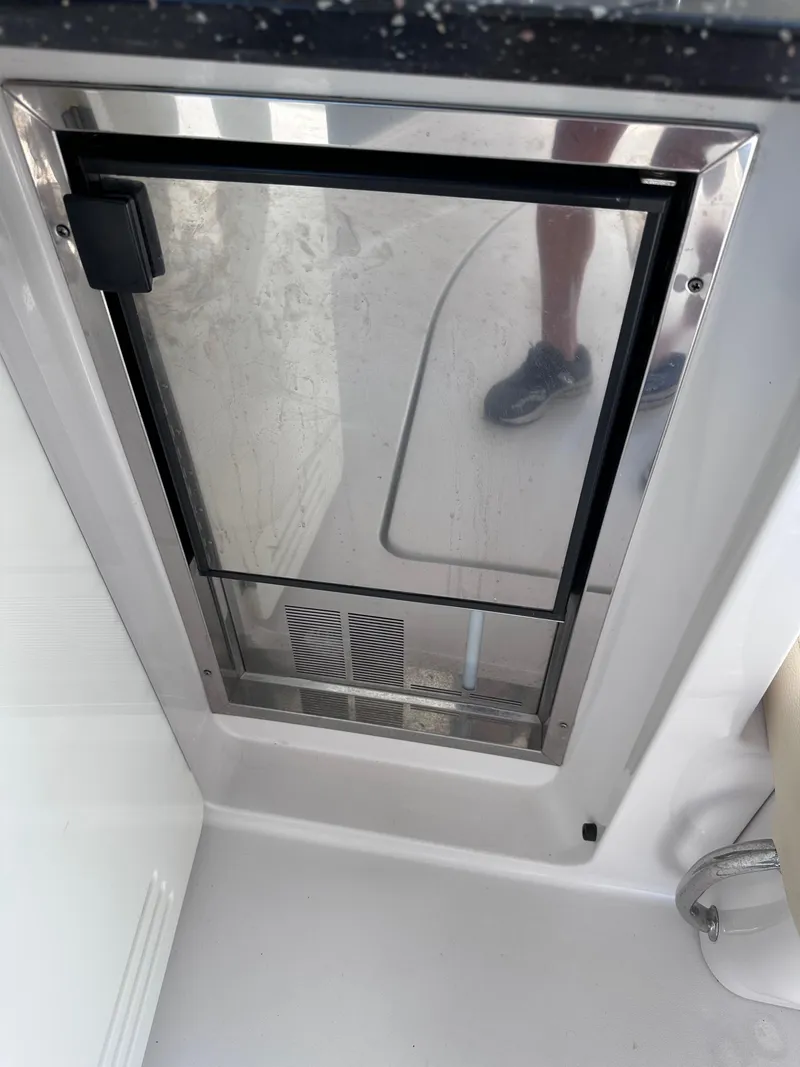 Slide: The Image of Stainless steel door on 2008 Four Winns V458 yacht, reflecting interior details. - 11