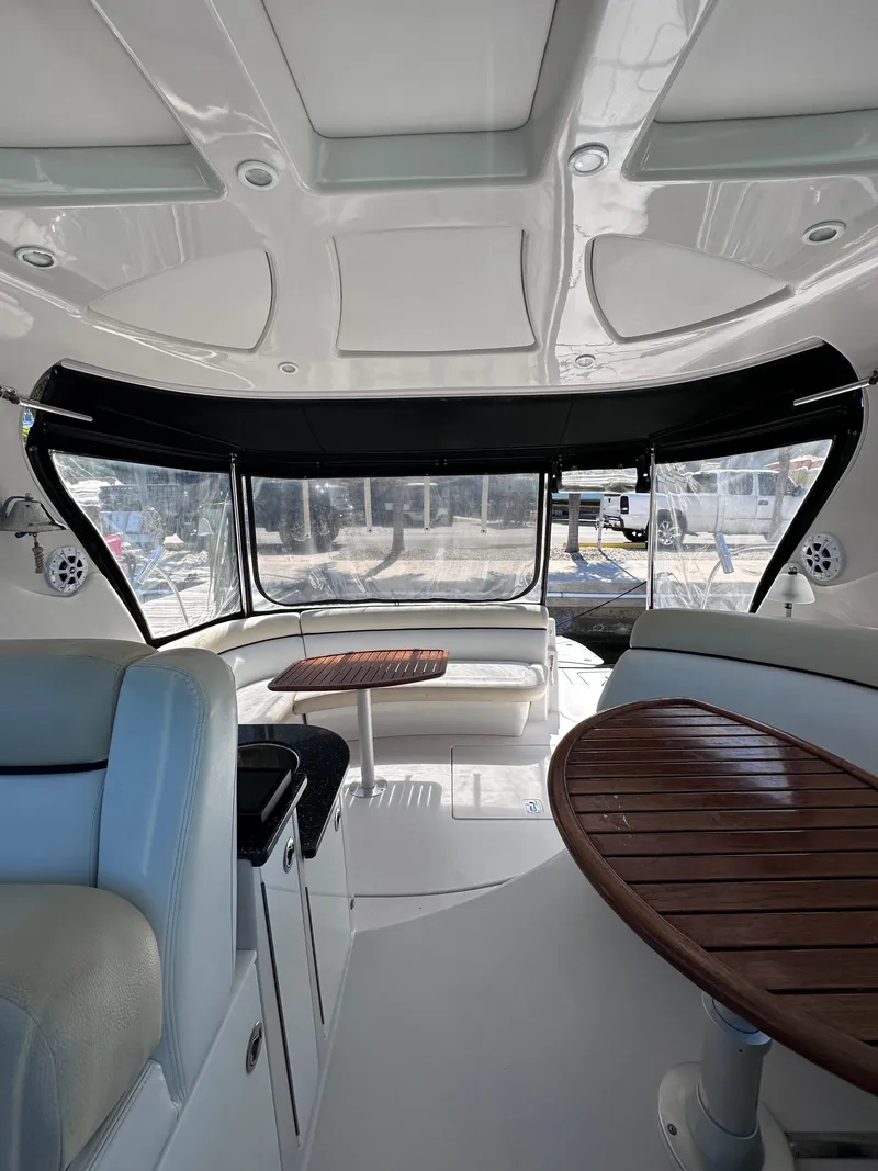 Slide: The Image of Interior of 2008 Four Winns V458 yacht with seating and wooden tables. - 12
