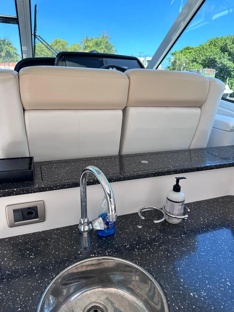 Slide: The Image of 2008 Four Winns V458 yacht interior with sink and countertop, featuring a sleek design. - 14