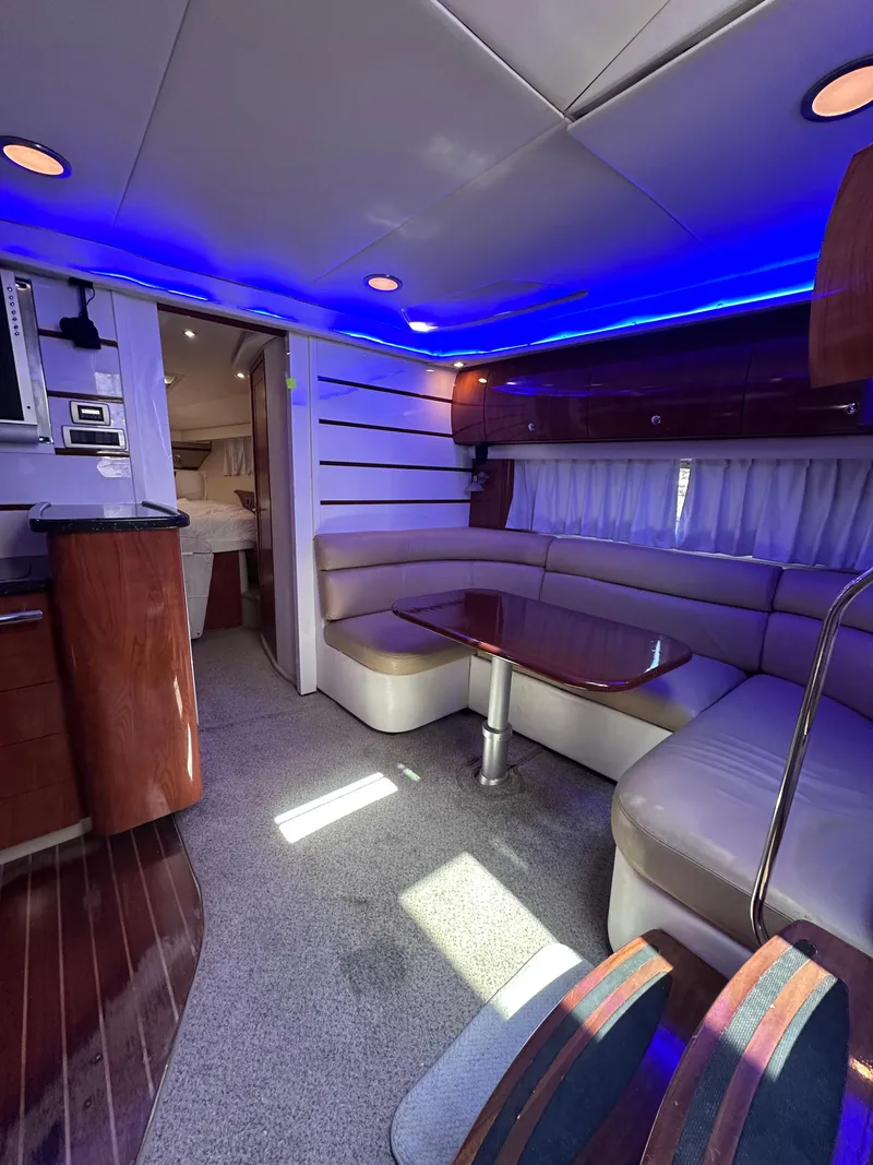 Slide: The Image of Luxurious 2008 Four Winns V458 yacht interior with blue LED lighting and elegant seating area. - 16