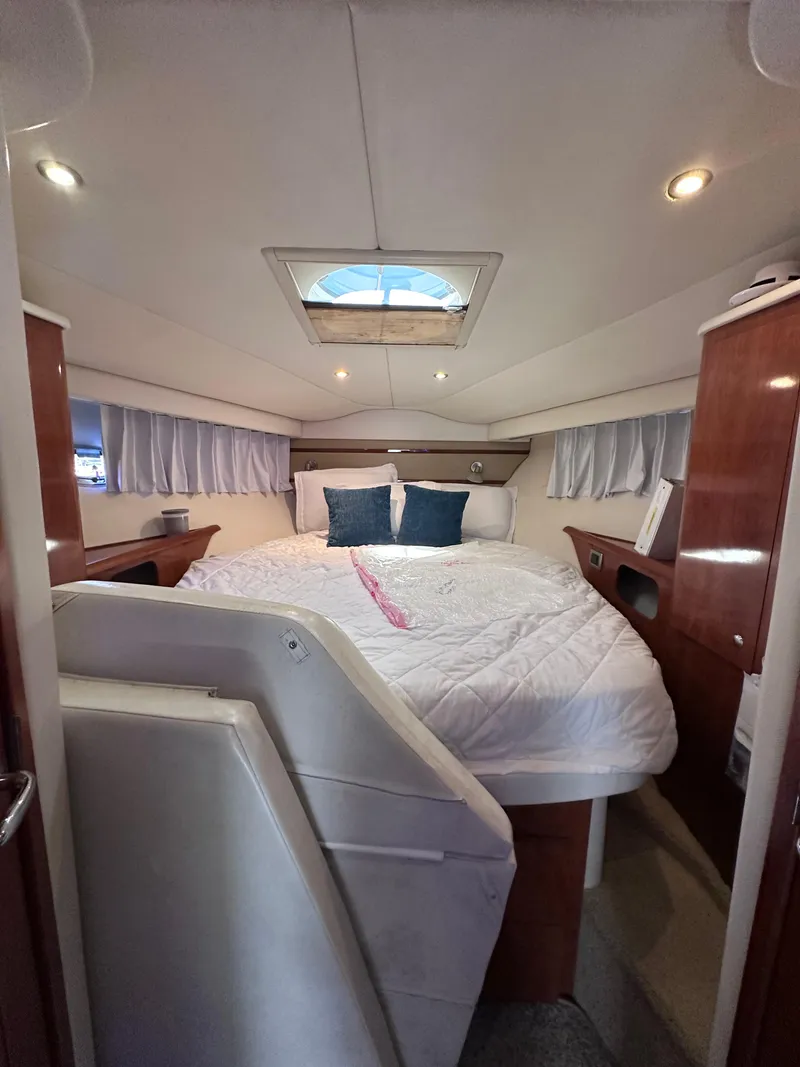Slide: The Image of Luxurious cabin interior of 2008 Four Winns V458 yacht with cozy bedding and elegant wood finishes. - 19