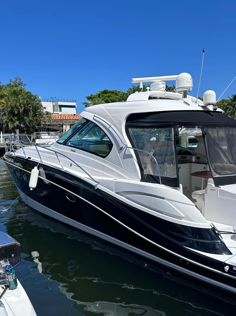 Slide: The Image of 2008 Four Winns V458 yacht docked in a marina under clear blue skies. - 2
