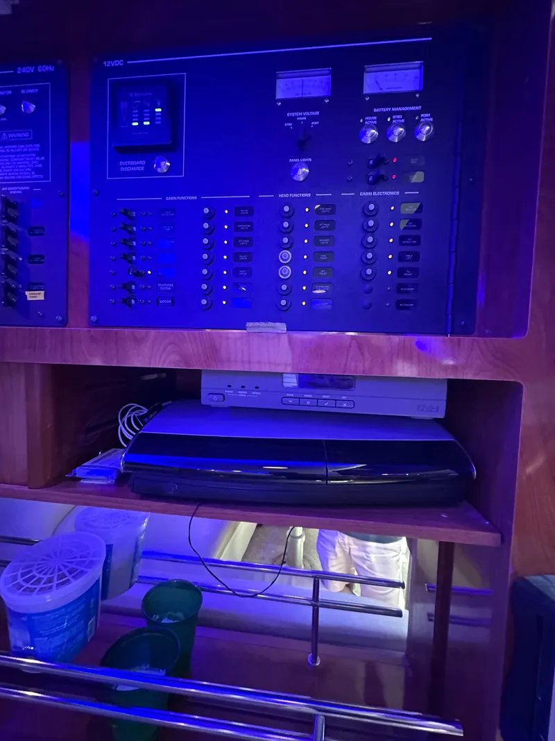 Slide: The Image of Control panel and electronics inside a 2008 Four Winns V458 boat, illuminated in blue light. - 25