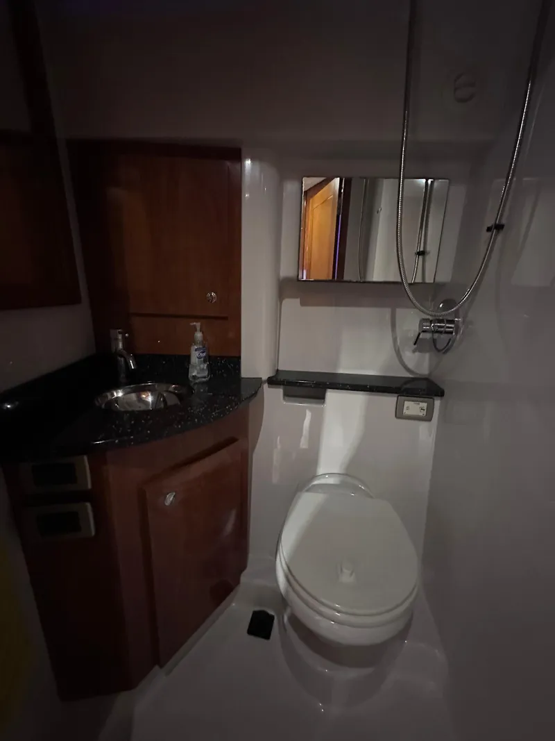 Slide: The Image of Compact bathroom in 2008 Four Winns V458 yacht with sink, toilet, and mirror. - 31