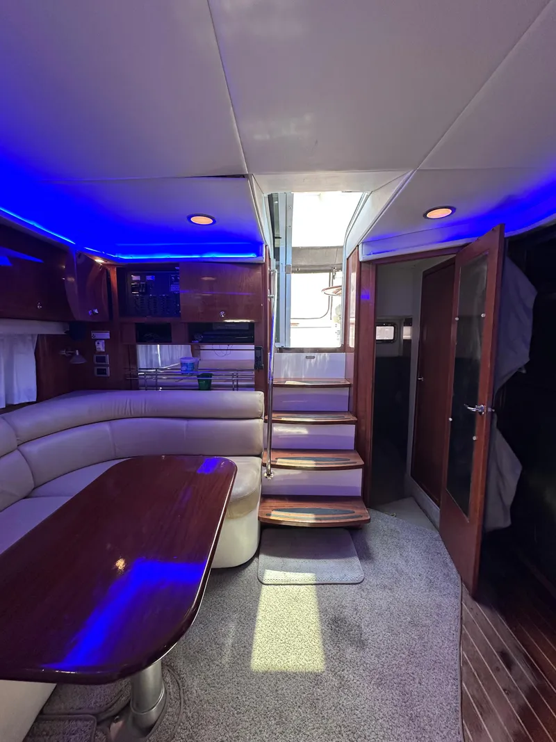 Slide: The Image of Luxurious 2008 Four Winns V458 yacht interior with blue LED lighting and elegant wood finishes. - 32