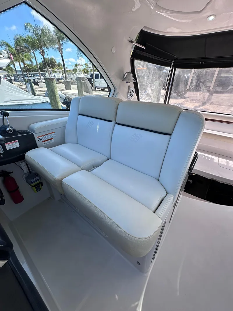 Slide: The Image of 2008 Four Winns V458 boat interior with white seating and panoramic windows. - 33