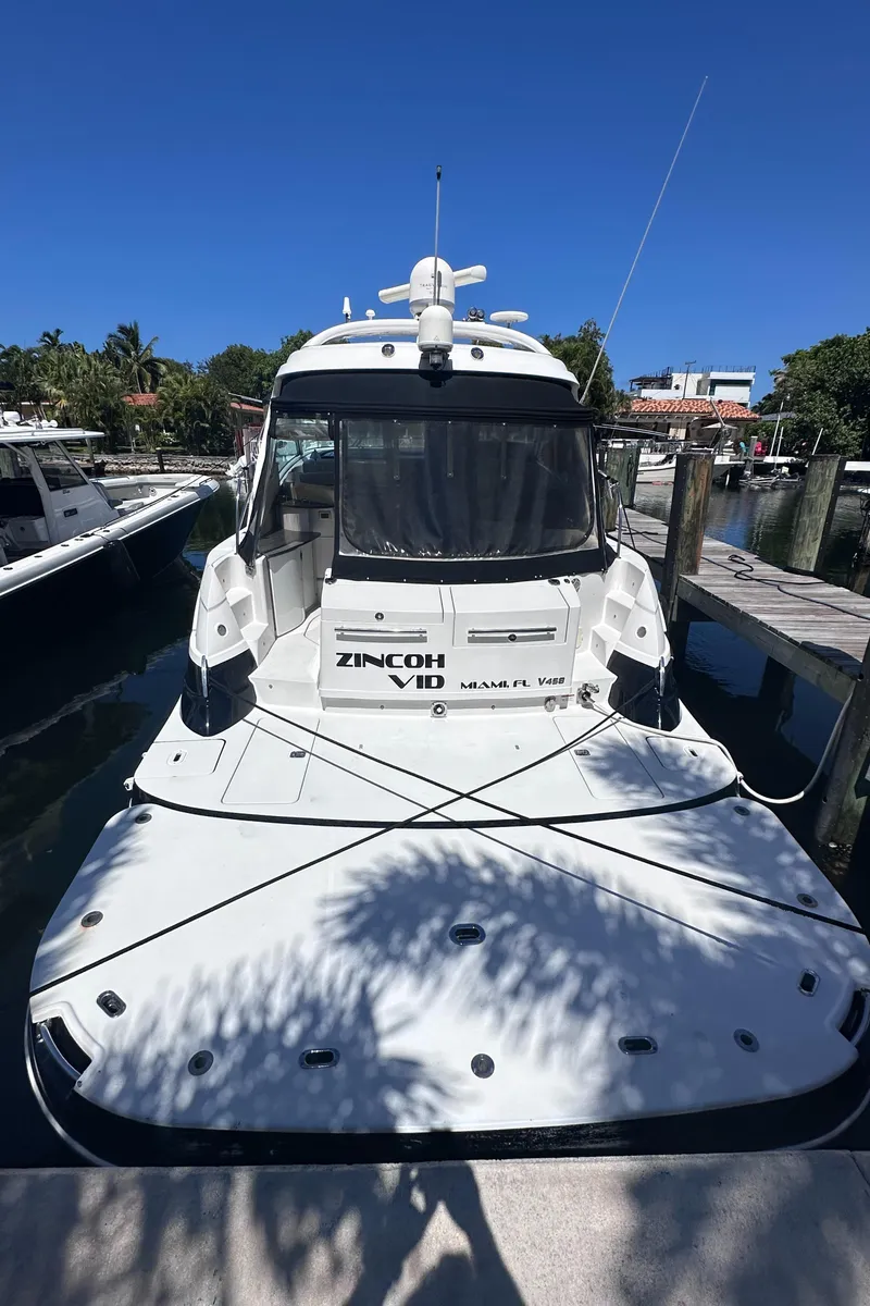 Slide: The Image of 2008 Four Winns V458 yacht docked, rear view, sunny day, marina setting. - 4