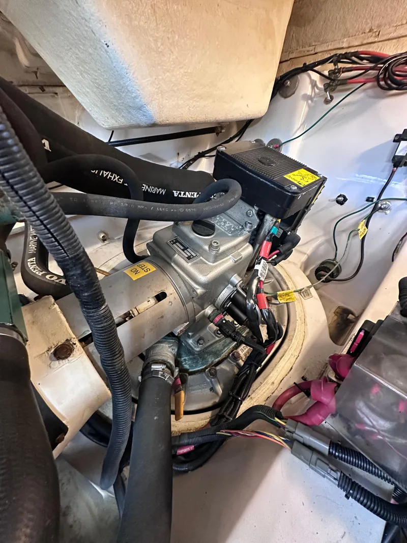 Slide: The Image of Engine compartment of a 2008 Four Winns V458 boat, showcasing mechanical components and wiring. - 45