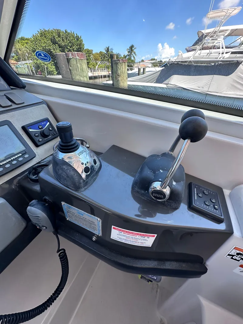 Slide: The Image of 2008 Four Winns V458 boat control panel with joystick and throttle lever. - 9