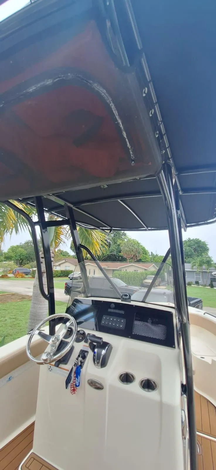 Slide: The Image of 2022 Scout 215 XSF boat interior with steering wheel and dashboard. - 10