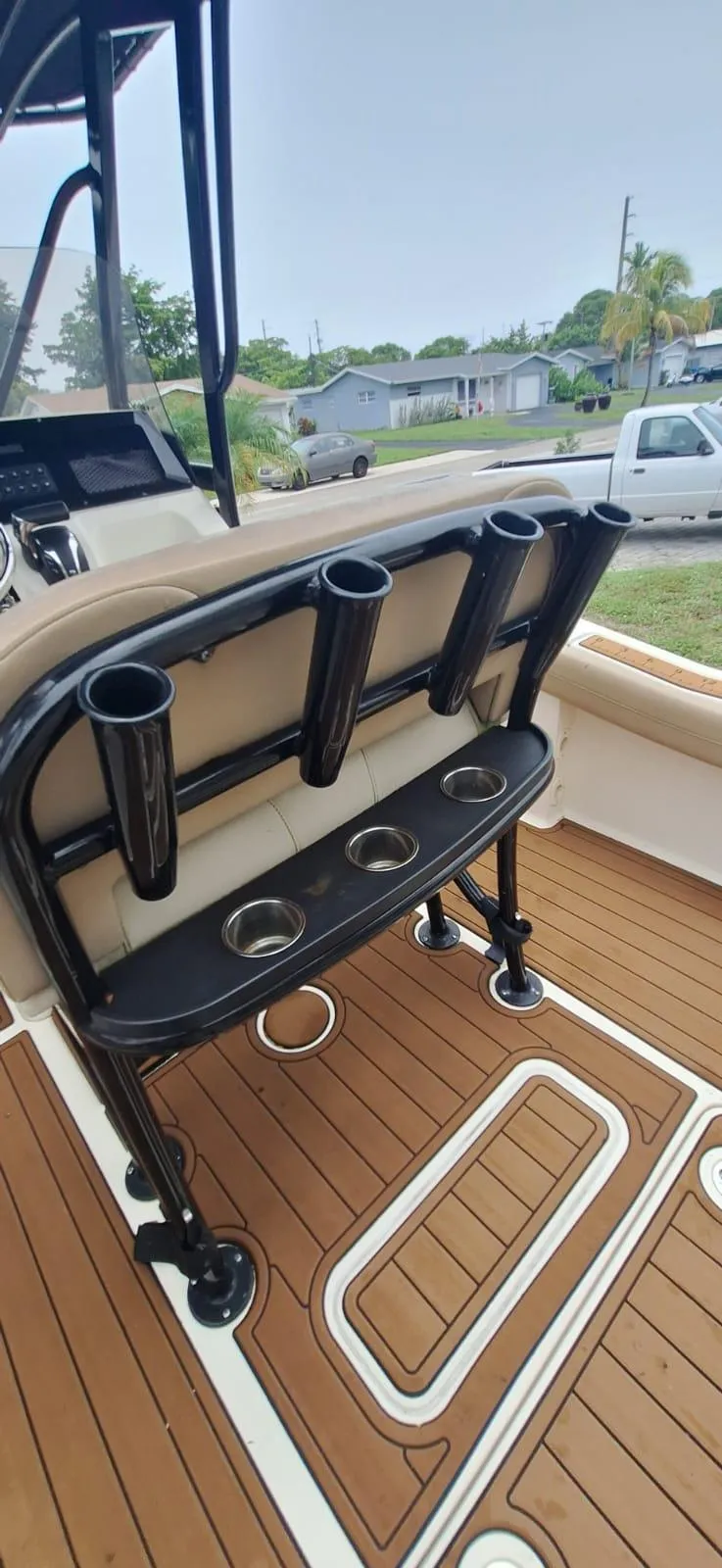 Slide: The Image of 2022 Scout 215 XSF boat interior with rod holders and cup holders on deck. - 11