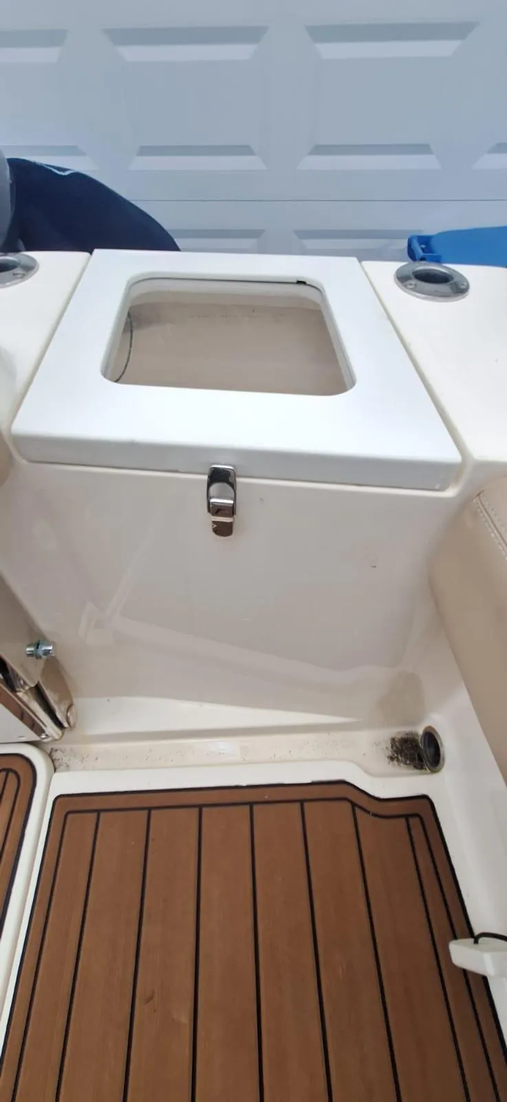 Slide: The Image of 2022 Scout 215 XSF boat deck with storage compartment and wood finish. - 12