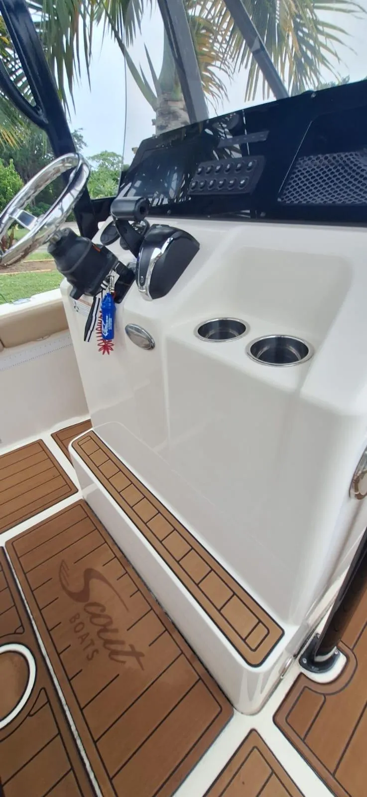 Slide: The Image of 2022 Scout 215 XSF boat console with steering wheel and cup holders. - 13