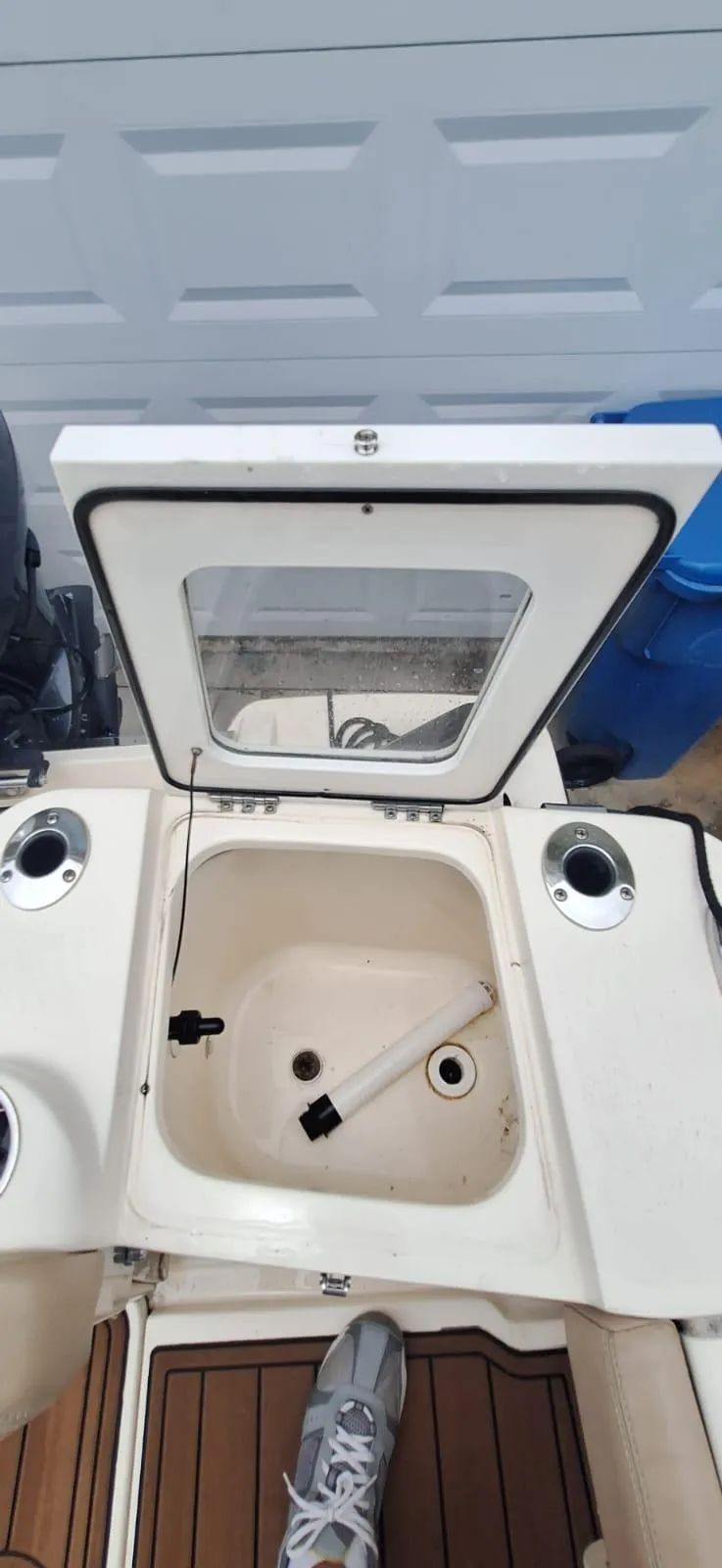 Slide: The Image of 2022 Scout 215 XSF boat interior with open storage compartment and cup holders. - 14