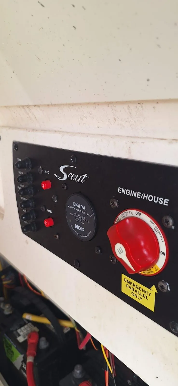 Slide: The Image of Control panel of a 2022 Scout 215 XSF boat with switches and emergency power dial. - 15