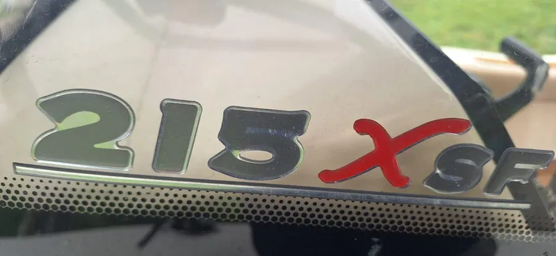 Slide: The Image of 2022 Scout 215 XSF logo on boat windshield, featuring bold silver and red lettering. - 16