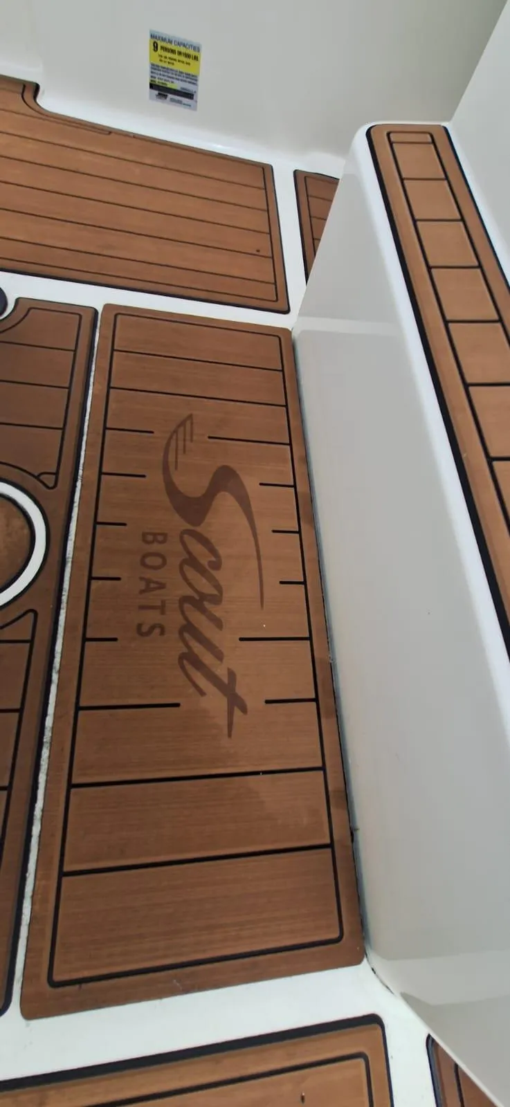 Slide: The Image of 2022 Scout 215 XSF boat deck with branded teak-style flooring. - 17
