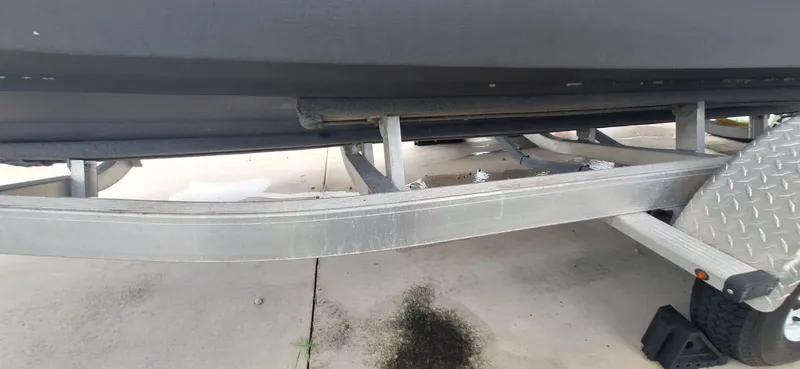 Slide: The Image of 2022 Scout 215 XSF boat on trailer, showing hull and trailer details. - 19