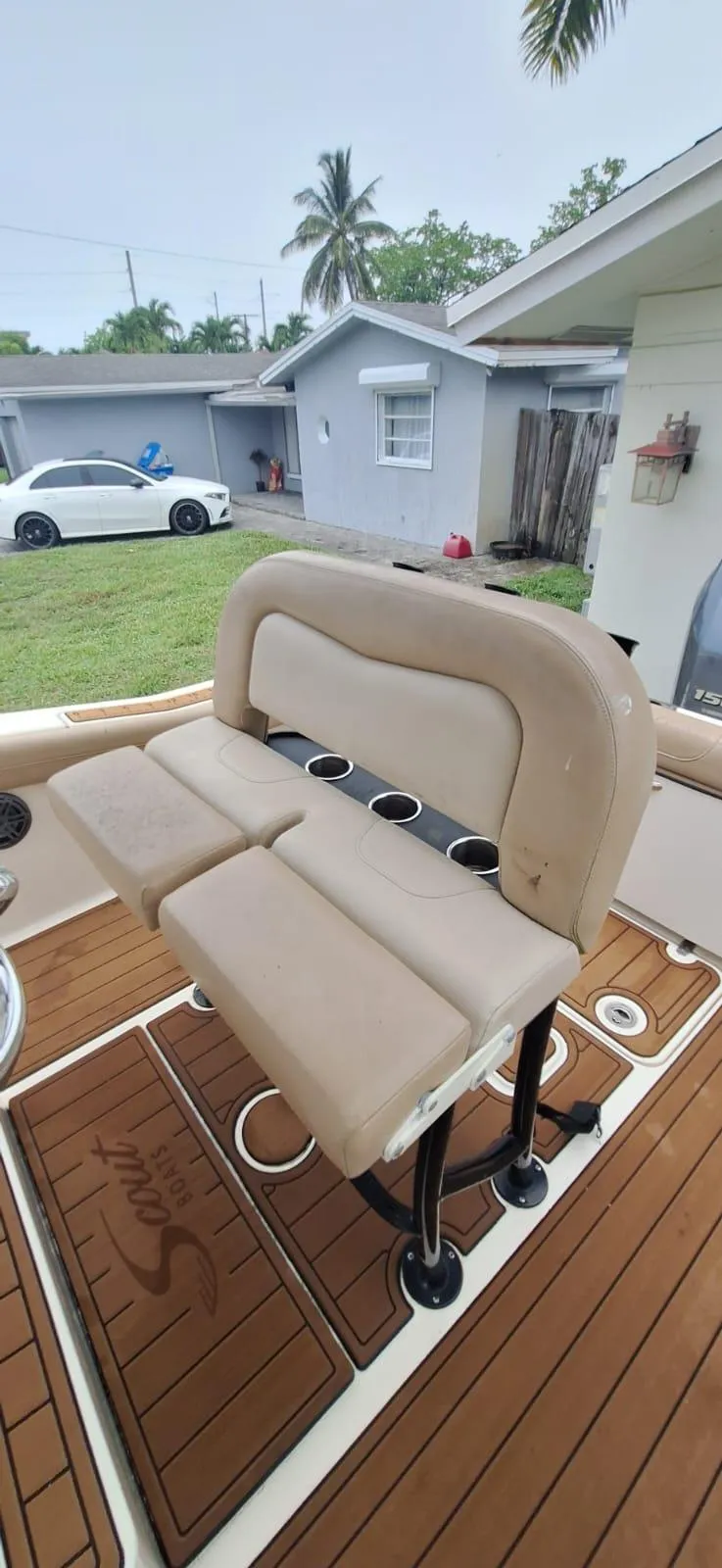 Slide: The Image of 2022 Scout 215 XSF boat interior with cushioned seating and cup holders. - 8