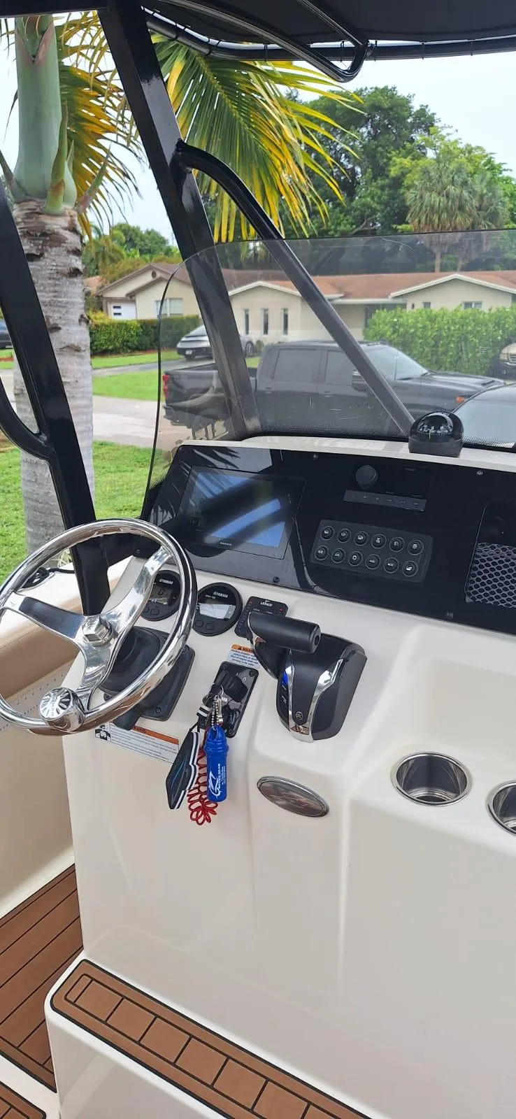 Slide: The Image of 2022 Scout 215 XSF boat dashboard with steering wheel and controls. - 9