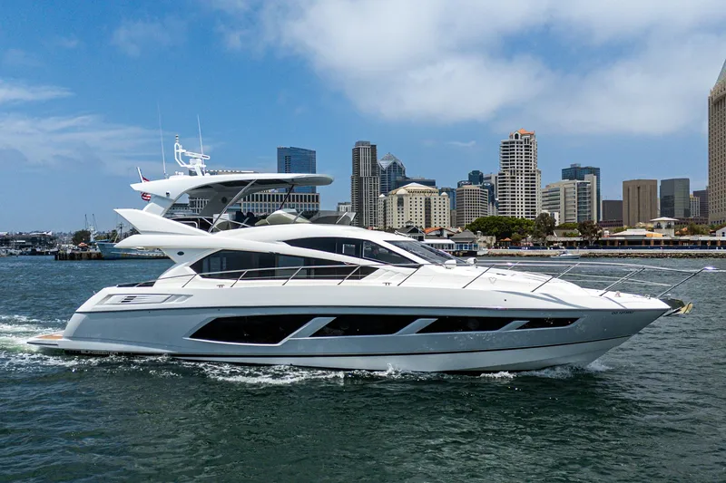 The Image of 2017 Sunseeker Manhattan 65 yacht cruising near city skyline. - 0
